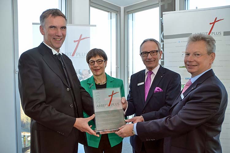 Bischof Jan Janssen und Renate Giesler von der EKD überreichten Martin Grapentin und seinem Vorstandskollegen Gerhard Fiand (von links) das Arbeitsplatzsiegel Arbeit plus.