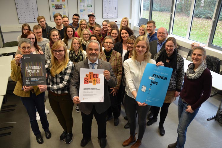 Landschaftspräsident Thomas Kossendey präsentiert den Siegerentwurf von Anne Prellberg, die beim Fototermin nicht anwesend war. Wiebke Himmel und Anna Lena Idel nahmen die Gratulationen der Lehrkräfte und der anderen Teilnehmer entgegen.